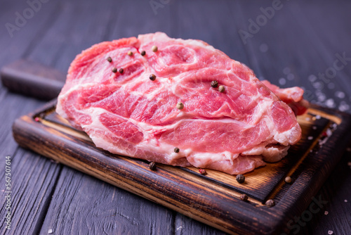a piece of raw pork meat on a wooden board