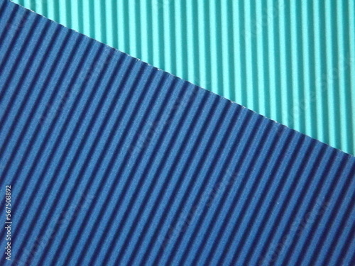 The corrugated surface is multicolored with parallel lines as a background black blue orange crimson pink light green orange and purple