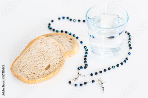 Fototapeta Fast concept with bread water and rosary