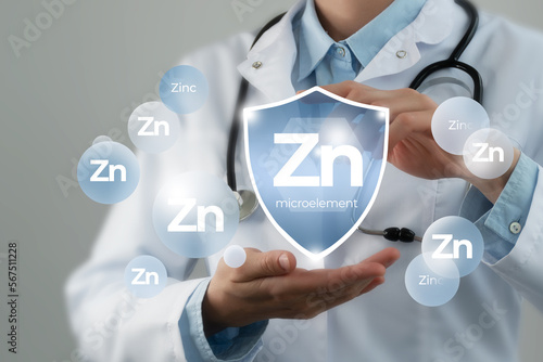 Microelement supplement concept. Shield in doctor`s hands with Zinc icon.