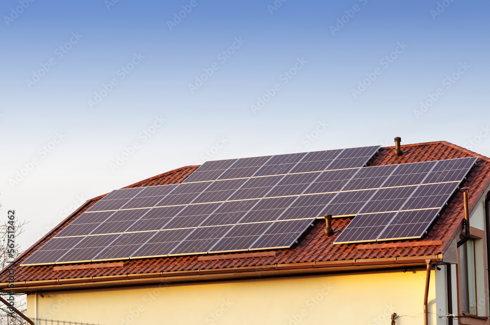 Solar panels on the roof of a private house, evening time
