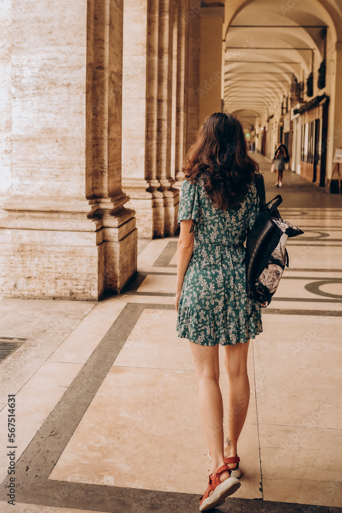 A beautiful woman walks with backpack in Turin, Italy. A beautiful woman walks with backpack in Turin, Italy.