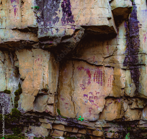Fototapeta Naklejka Na Ścianę i Meble -  prehistoric cave paintings on the rock with hunting scenes and geometric symbols