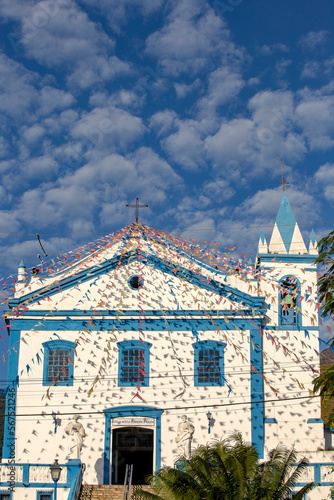 Church of Our Lady of Help, or Nossa Senhora d Ajuda in portuguese, decorated with June festival flags. Ilhabela, colonial town on the coast of Sao Paulo state, Brazil photo