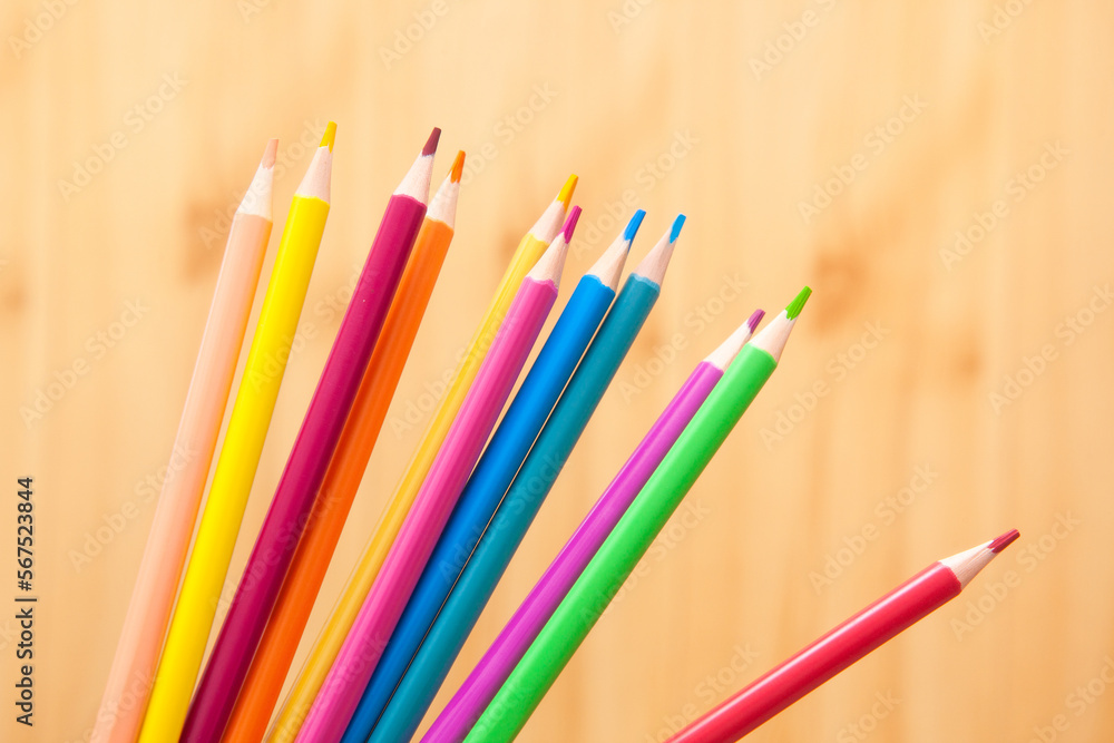 Color pencils  on wooden background, back to school and art education concept card 