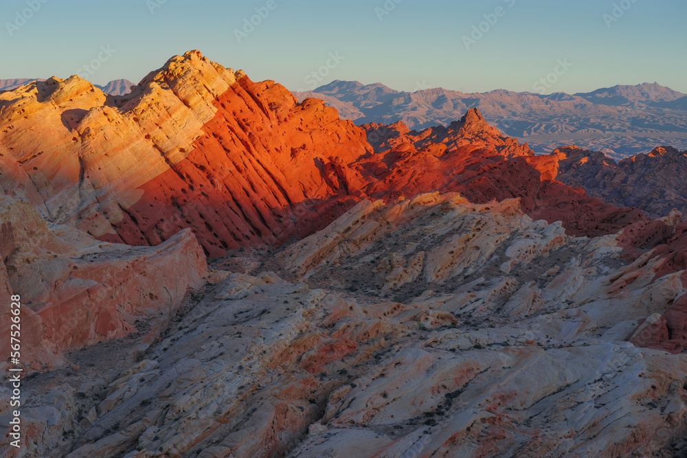Colorful red sandstone formations shown at Valley of Fire in Nevada, United States. The park has a National Natural Landmark designation and is located within the Mojave Desert.