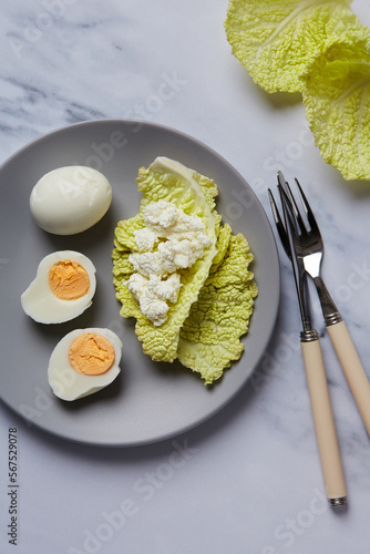 chicken eggs with cabbage leaf on a plate