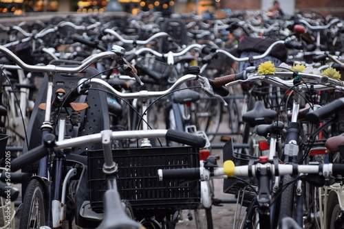 Details of numerous bicycles on a parking lot with blurred background in Copenhagen, Denmark