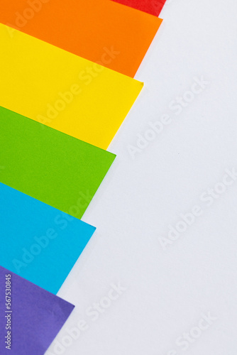 Close up of rainbow coloured cards with copy space on white background
