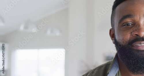 Half face portrait of happy bearded african american man smiling, with copy space, slow motion photo
