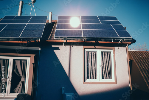 Solar panels on the roof of a building, active at day. cute realistic village...