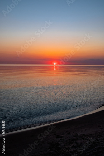 A perfect sunset into the sea, clear skies, soft colours, no people photo