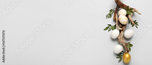 Beautiful Easter eggs, tree branch and leaves on white background with space for text