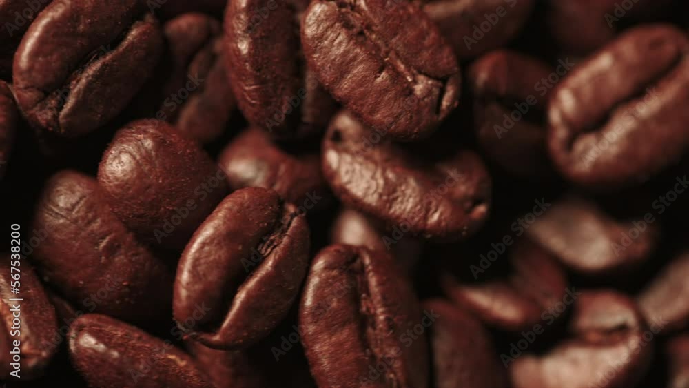 Background of roasted coffee beans. Many fried coffee grains are poured on top. Selective focus. Close up. The concept of an advertising banner for a coffee shop or commodity production. Background of roasted coffee beans. Many fried coffee grains are poured on top. Selective focus. Close up. The concept of an advertising banner for a coffee shop or commodity production.