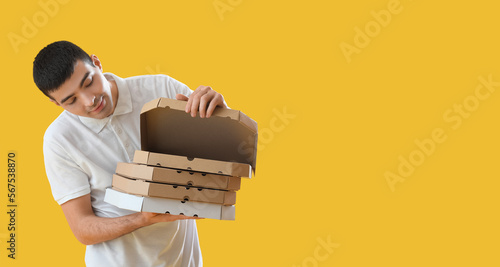 Young man and many pizza bo...