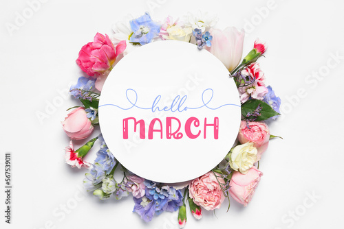 Card with text HELLO, MARCH and spring flowers on light background