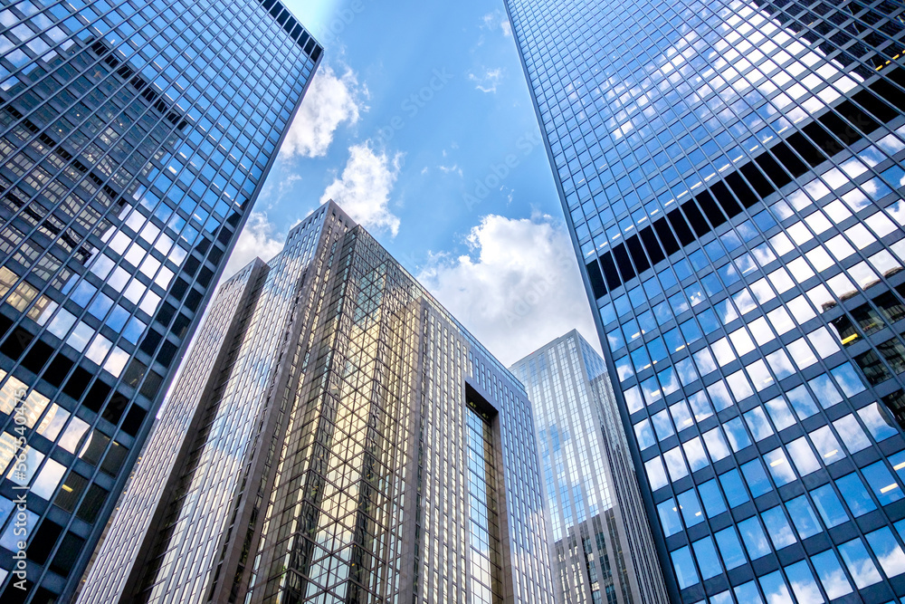 Blue sky and clouds reflect in the windows of downtown office building in Toronto Canada.