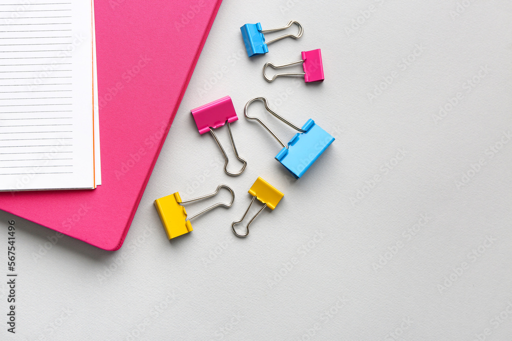 Notebooks and paper clips on light background Notebooks and paper clips on light background
