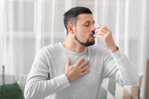 Sick man with inhaler at home