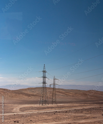 high tension towers carry electricity in the desert