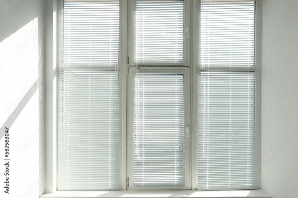 Stylish window with horizontal blinds in room Stylish window with horizontal blinds in room