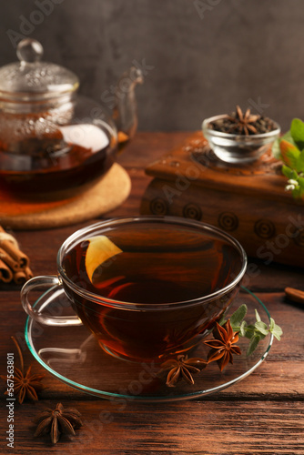 Aromatic tea with anise stars and mint on wooden table