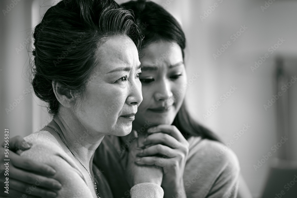 grieve asian senior mother and adult daughter grieve asian senior mother and adult daughter