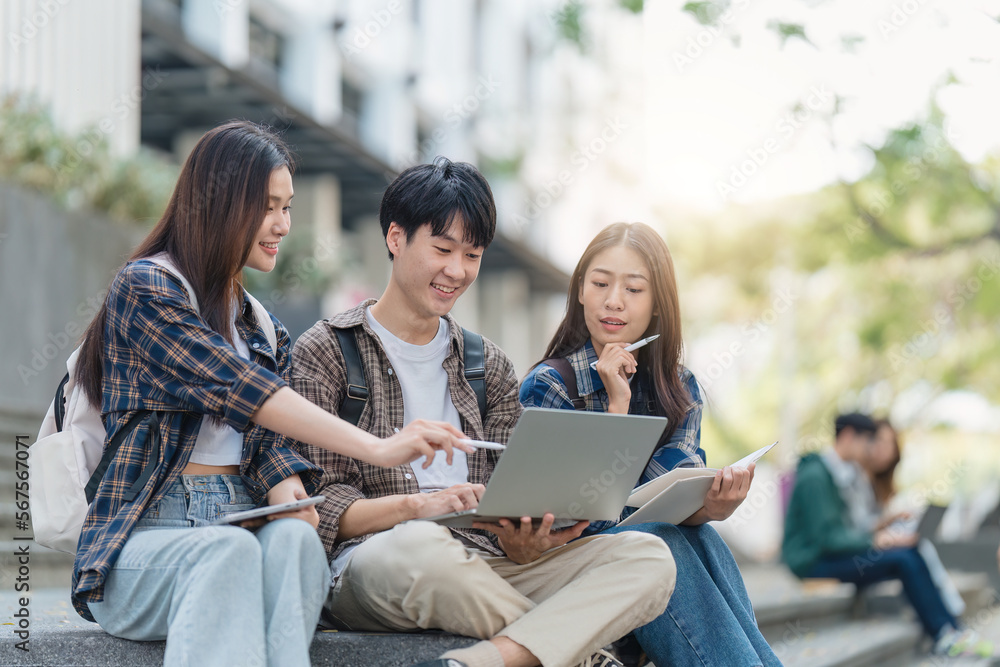 Beautiful young Asian woman college student with friends at outdoors. College student working on the college campus Beautiful young Asian woman college student with friends at outdoors. College student working on the college campus