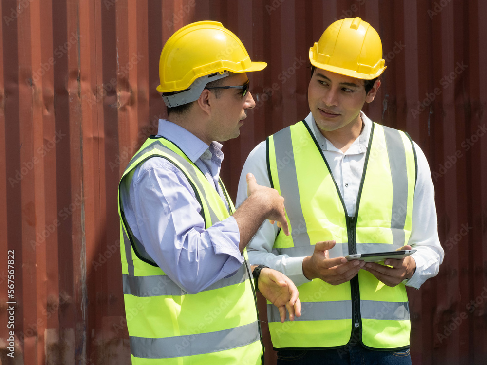 Two people engineer male labor staff employee wear uniform yellow hardhat helmet safety talk speak discussion notebook tablet report information import export shipping logistic cargo person teamwork Two people engineer male labor staff employee wear uniform yellow hardhat helmet safety talk speak discussion notebook tablet report information import export shipping logistic cargo person teamwork