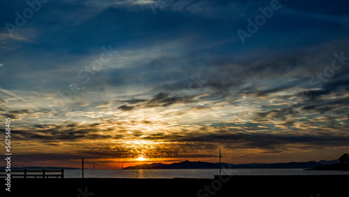 Winter sunset across the San Francisco Bay with orange, yellow blue sky. 