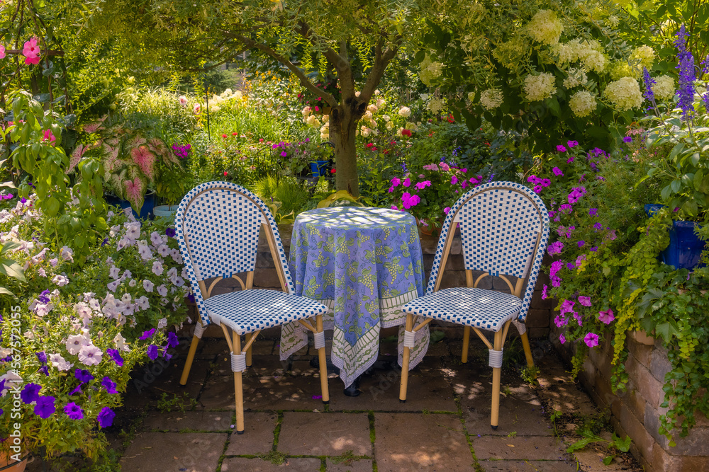 Awash with color this vibrant terrace garden, lush green foliage, chartreuse and violet blooms create a romantic, European feel along with French blue tableclothed bistro table and chairs. Awash with color this vibrant terrace garden, lush green foliage, chartreuse and violet blooms create a romantic, European feel along with French blue tableclothed bistro table and chairs.