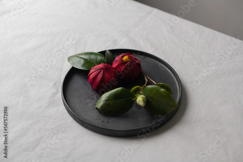 japanese sushi like camellia on a black plate