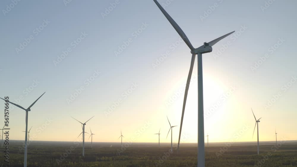 Wind farm panning shot during sunset in the afternoon, outdoor landscape of scenic wind turbines during dawn Wind farm panning shot during sunset in the afternoon, outdoor landscape of scenic wind turbines during dawn