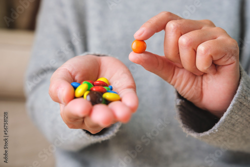 Closeup image of hands holding and showing colorful chocolate candy