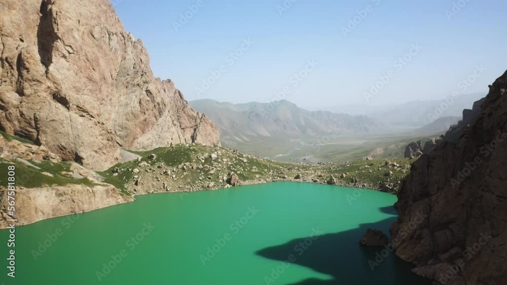 Slow epic cinematic revealing drone shot over the Kel-Suu lake and its ravine in Kyrgyzstan Slow epic cinematic revealing drone shot over the Kel-Suu lake and its ravine in Kyrgyzstan