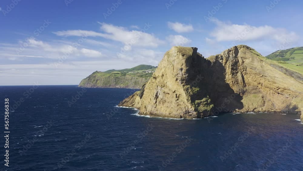 dramatic vulcanic cliffs revealing Rosais village, green vegetation and lava formations next to the sea drone footage, Sao Jorge island, Azores, Portugal dramatic vulcanic cliffs revealing Rosais village, green vegetation and lava formations next to the sea drone footage, Sao Jorge island, Azores, Portugal