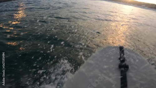 Young man riding perfect wave at Guincho surf spot in Cascais. Amateur surfer rides the wave with black final. great floater.