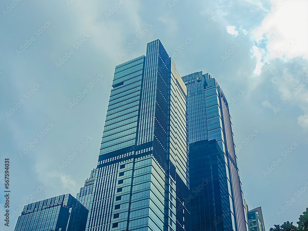 a city skyline with a tall building. a tall building with a sky background