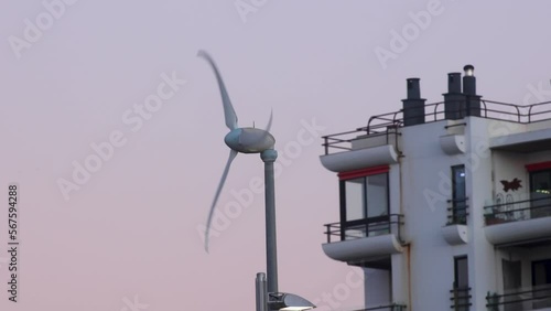 closeup of Wind turbines generate electricity, windmill silhouettes at sunset
