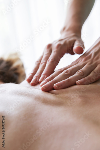 Shiatsu massage on female back. Health, body care, medicine concept. Copy space. Vertical.