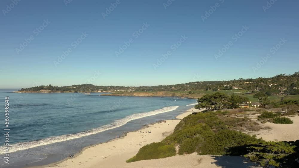 Carmel California beach during a sunny day with blue sky. Drone flyover beach and tourists. Carmel California beach during a sunny day with blue sky. Drone flyover beach and tourists.