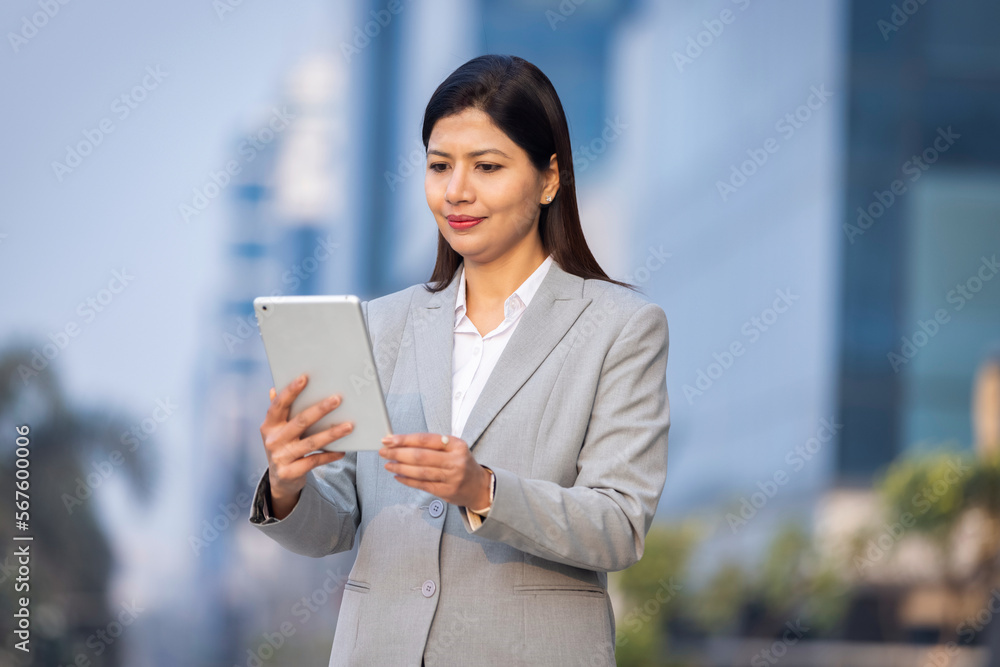 Confident businesswoman using a digital tablet. Confident businesswoman using a digital tablet.