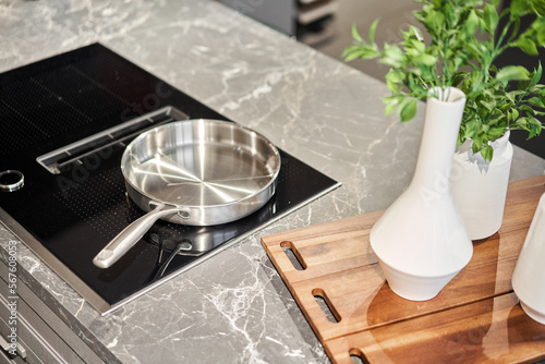 Fényképezés New cookware set on black induction hob in modern kitchen