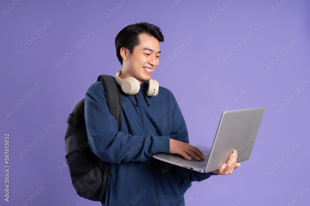 Asian male student portrait on purple background Asian male student portrait on purple background