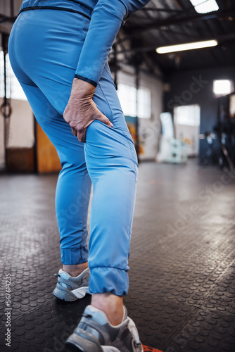Leg pain, injury and accident at a gym after exercise, training or sport workout with bruise. Fitness, sports and woman athlete limping from a swollen, inflammation or sprain muscle at a studio. photo