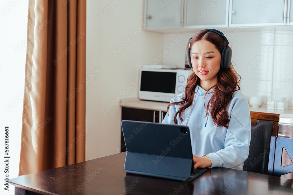 Closeup of smiling freelance asian woman working at home Closeup of smiling freelance asian woman working at home