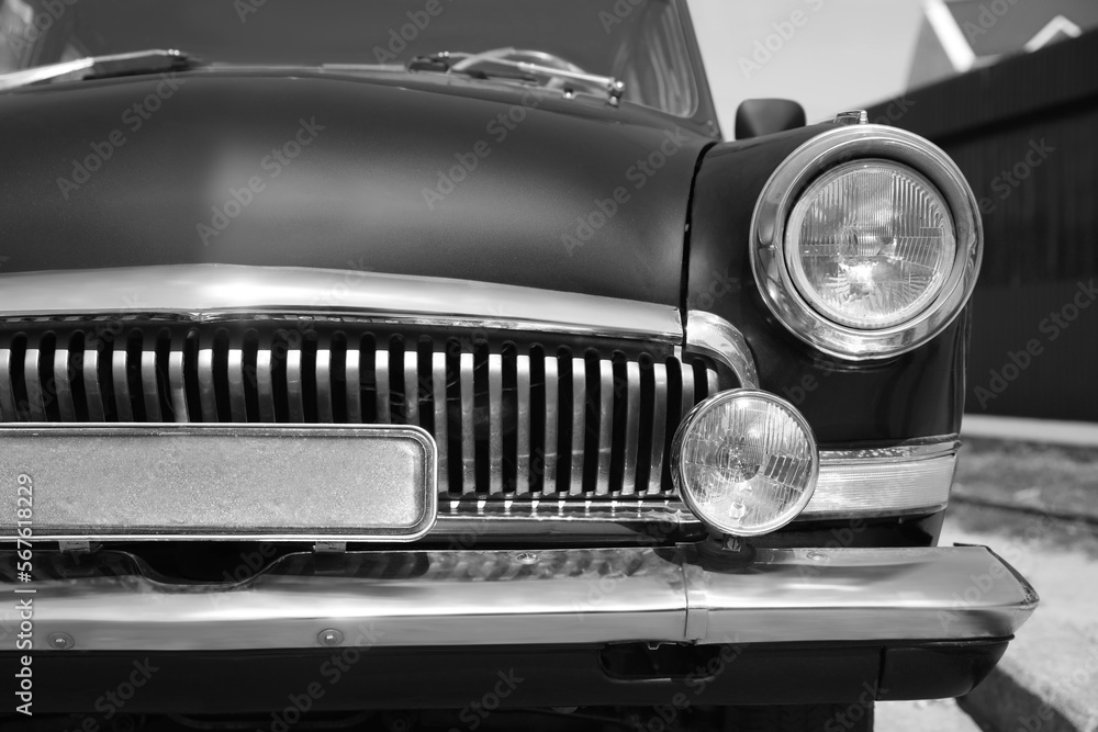 Beautiful retro car on street, closeup. Black and white effect
