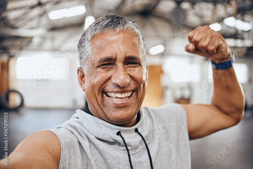 Muscle, exercise and selfie portrait of old man in gym show biceps for motivation, wellness and cardio workout. Smile, healthy body and face of senior male after training, sports and fitness goals