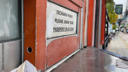 Wallpaper Mural Exchange money please show your passport or ID card sign at closed currency exchange counter with blurred monk walking on sidewalk outdoor daytime, Thailand Torontodigital.ca