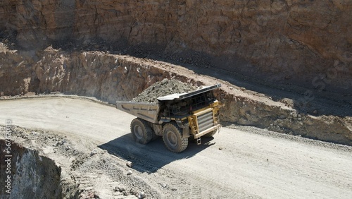Large quarry dump truck full of stones. Transporting the ore into the crusher. Mining truck mining machinery, transport the material for production.